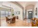 Elegant dining room with tray ceiling, chandelier, wood floors, and large windows at 7360 S Owens Ct, Littleton, CO 80127