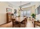 Dining room with wood floors, chandelier, and connection to the kitchen area at 7360 S Owens Ct, Littleton, CO 80127