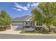 Charming single-story home with a two-car garage, steps to entry, and mature trees in the front yard at 7360 S Owens Ct, Littleton, CO 80127