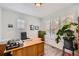 Bright home office with wood desk, plantation shutters, and a view of the outdoors at 7360 S Owens Ct, Littleton, CO 80127