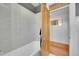 Clean bathroom featuring light-colored subway tile, classic fixtures, and natural wood door at 54 S Emerson St # 4, Denver, CO 80209