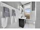 Charming bathroom with wainscoting, black vanity, and classic black and white accents at 54 S Emerson St # 4, Denver, CO 80209