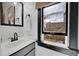 Bright bathroom with a sleek vanity, modern mirror, and a large window for natural light at 54 S Emerson St # 4, Denver, CO 80209