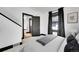 Cozy bedroom with neutral carpet, black trim, and natural light from a window, creating a relaxing atmosphere at 54 S Emerson St # 4, Denver, CO 80209