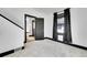 Bedroom featuring neutral carpet, black trim, and natural light from a window, creating a serene and minimalist aesthetic at 54 S Emerson St # 4, Denver, CO 80209