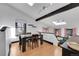 Bright dining room with skylights, hardwood floors, and open floor plan to the living room at 54 S Emerson St # 4, Denver, CO 80209