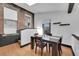 Inviting dining room with hardwood floors, a dark wood table, and exposed brick accents at 54 S Emerson St # 4, Denver, CO 80209