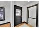Entryway showcasing hardwood floors and black trim around the doorway and window at 54 S Emerson St # 4, Denver, CO 80209