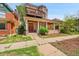 Unique stone house with a covered porch, balcony, and charming architectural details at 54 S Emerson St # 4, Denver, CO 80209