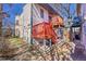 Rear exterior view showcasing a multi-level deck and mature landscaping at 54 S Emerson St # 4, Denver, CO 80209