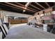 Spacious garage featuring exposed wood beams, brick accents, and ample space for storage and parking at 54 S Emerson St # 4, Denver, CO 80209