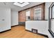 Bright living room featuring an exposed brick wall, light bamboo floors, and a skylight for ample natural light at 54 S Emerson St # 4, Denver, CO 80209