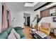 Open-concept living room featuring a skylight, exposed brick, and modern decor with comfortable seating at 54 S Emerson St # 4, Denver, CO 80209