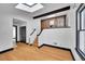 Modern living area with hardwood floors, brick accents, and a well-lit staircase at 54 S Emerson St # 4, Denver, CO 80209