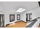 Bright living room with skylight, hardwood flooring, black trim and a modern aesthetic at 54 S Emerson St # 4, Denver, CO 80209