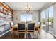 Comfortable dining room featuring modern lighting, a decorative accent wall, and sliding glass doors to the deck at 18083 Telford Ave, Parker, CO 80134