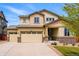 Inviting two-story home featuring a three-car garage, landscaped yard, and a charming covered entryway at 18083 Telford Ave, Parker, CO 80134