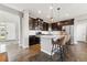 Modern kitchen with a granite-top island, stainless steel appliances, dark cabinetry, and pendant lighting at 18083 Telford Ave, Parker, CO 80134