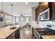 Spacious kitchen with stainless steel appliances, granite countertops, and a view into the living room at 18083 Telford Ave, Parker, CO 80134