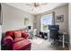 Cozy office space with a comfortable red chair, dual workstations, and a bright window view at 18083 Telford Ave, Parker, CO 80134