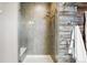 Stylish shower with a built-in seat and modern fixtures and wood-look wall at 18083 Telford Ave, Parker, CO 80134