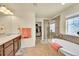 Elegant bathroom with soaking tub, glass shower, vanity, and walk-in closet at 5722 S Flat Rock Way, Aurora, CO 80016