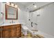 Bright bathroom with white subway tile shower, a glass shower door, and marble vanity at 5722 S Flat Rock Way, Aurora, CO 80016