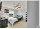 This cozy bedroom features a ceiling fan and a large window with a street view at 5722 S Flat Rock Way, Aurora, CO 80016