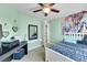 Bright bedroom with an elephant-themed tapestry and a ceiling fan at 5722 S Flat Rock Way, Aurora, CO 80016