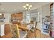 Dining room near kitchen features hardwood floors, a chandelier, and natural light at 5722 S Flat Rock Way, Aurora, CO 80016