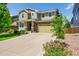 Charming two-story home with a well-manicured lawn, a long driveway, and a two-car garage at 5722 S Flat Rock Way, Aurora, CO 80016