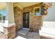 Welcoming front porch with stone accents and decorative bear figurines at 5722 S Flat Rock Way, Aurora, CO 80016