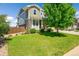 Well-maintained front yard featuring lush green grass, landscaping, and a mature shade tree at 5722 S Flat Rock Way, Aurora, CO 80016