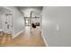 Inviting hallway with hardwood floors connecting the bathroom, living room and exterior french doors at 5722 S Flat Rock Way, Aurora, CO 80016