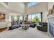 Spacious living room with large windows providing natural light and backyard views at 5722 S Flat Rock Way, Aurora, CO 80016