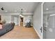 Open living room with hardwood floors, recessed lighting, glass door entrance and large leather sectional at 5722 S Flat Rock Way, Aurora, CO 80016