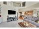 Open-concept living room features plush seating and easy access to the kitchen at 5722 S Flat Rock Way, Aurora, CO 80016