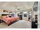 Spacious main bedroom featuring a tray ceiling, a ceiling fan, and well lit windows at 5722 S Flat Rock Way, Aurora, CO 80016