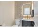 Modern bathroom with lighted mirror, textured tile, and gold fixtures creates a luxurious space at 1130 S Harrison St, Denver, CO 80210