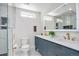 Bright bathroom featuring double sinks, gold fixtures, and a large mirror, showcasing modern elegance at 1130 S Harrison St, Denver, CO 80210