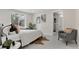 Bright bedroom features a large slider, cozy seating area, and ensuite bathroom for ultimate relaxation at 1130 S Harrison St, Denver, CO 80210