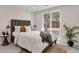 Relaxing bedroom boasts a plush bed, large window, and minimalist decor for peaceful rest at 1130 S Harrison St, Denver, CO 80210