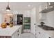 Well-equipped kitchen features white cabinetry, stainless appliances, and stylish island for cooking and gathering at 1130 S Harrison St, Denver, CO 80210