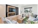 Inviting living room offering a sleek fireplace, hardwood floors and modern decor at 1130 S Harrison St, Denver, CO 80210