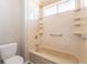 Shower and tub combo featuring a detachable shower head and built-in shelving at 3512 S Kittredge St # C, Aurora, CO 80013