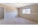 Neutral bedroom featuring a window, carpet flooring, and an attached doorway at 3512 S Kittredge St # C, Aurora, CO 80013