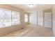 Bright bedroom with two windows, carpet flooring, and a large closet space at 3512 S Kittredge St # C, Aurora, CO 80013