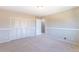 Spacious bedroom with carpet flooring, closet doors, and an open doorway at 3512 S Kittredge St # C, Aurora, CO 80013