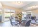 Dining area with glass table and outdoor patio access offers a seamless indoor-outdoor living experience at 3512 S Kittredge St # C, Aurora, CO 80013