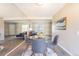 Open concept dining area with adjacent living space boasts a mirrored wall creating depth and style at 3512 S Kittredge St # C, Aurora, CO 80013